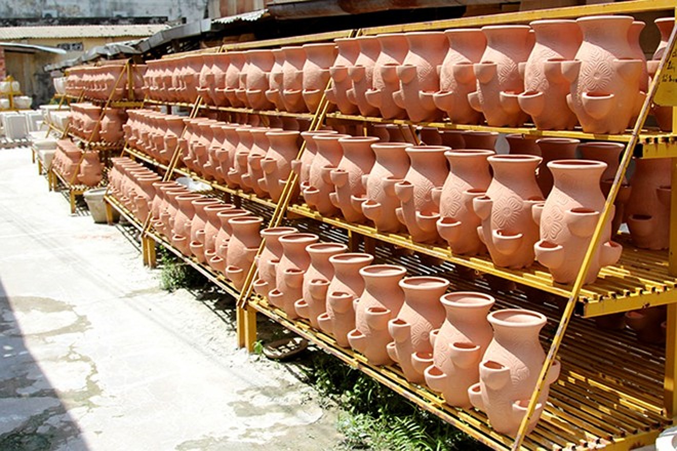Rows of terracotta pots drying on the factory racks